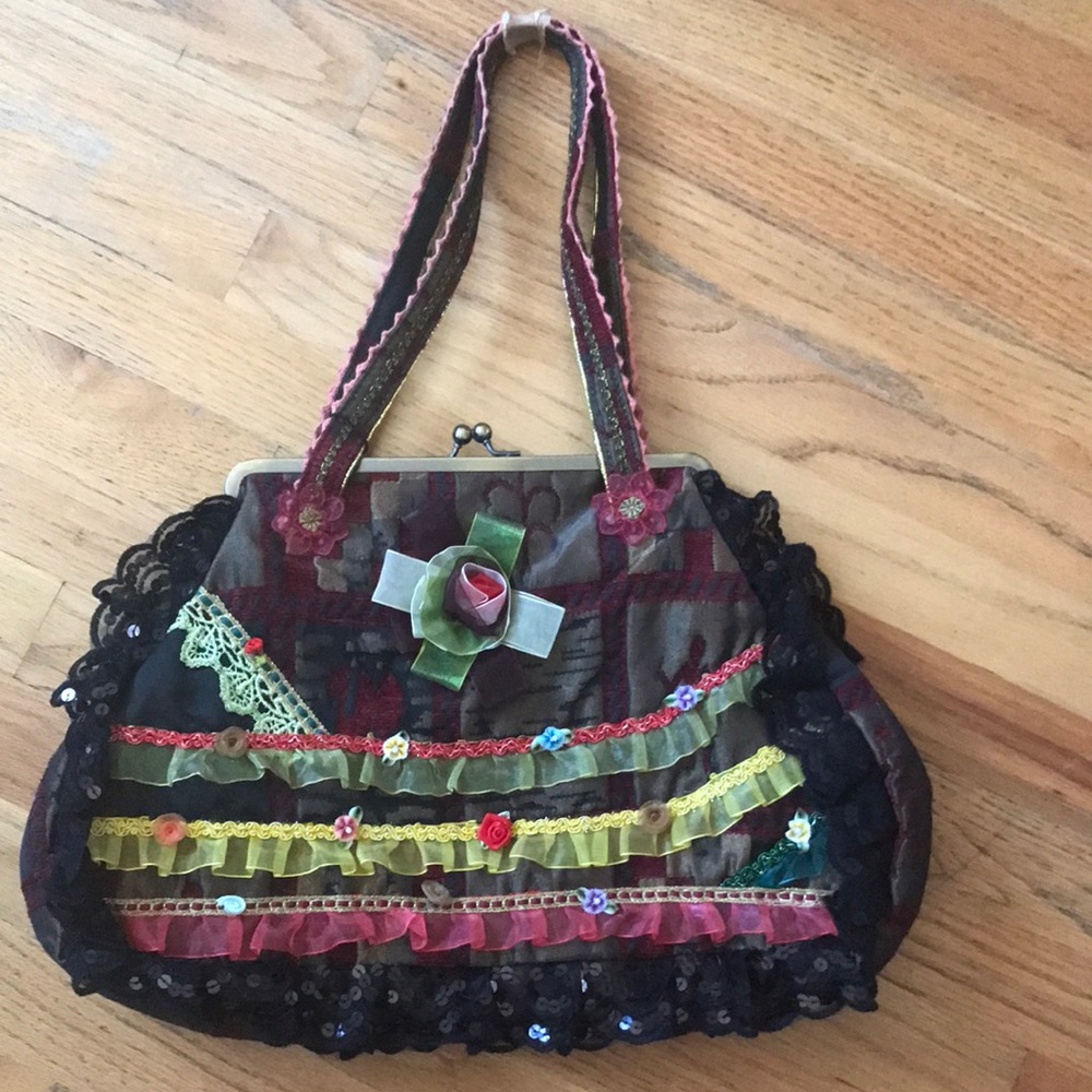 Handmade bag with colorful flowers and ribbons. Very nice handbag. It is unique.